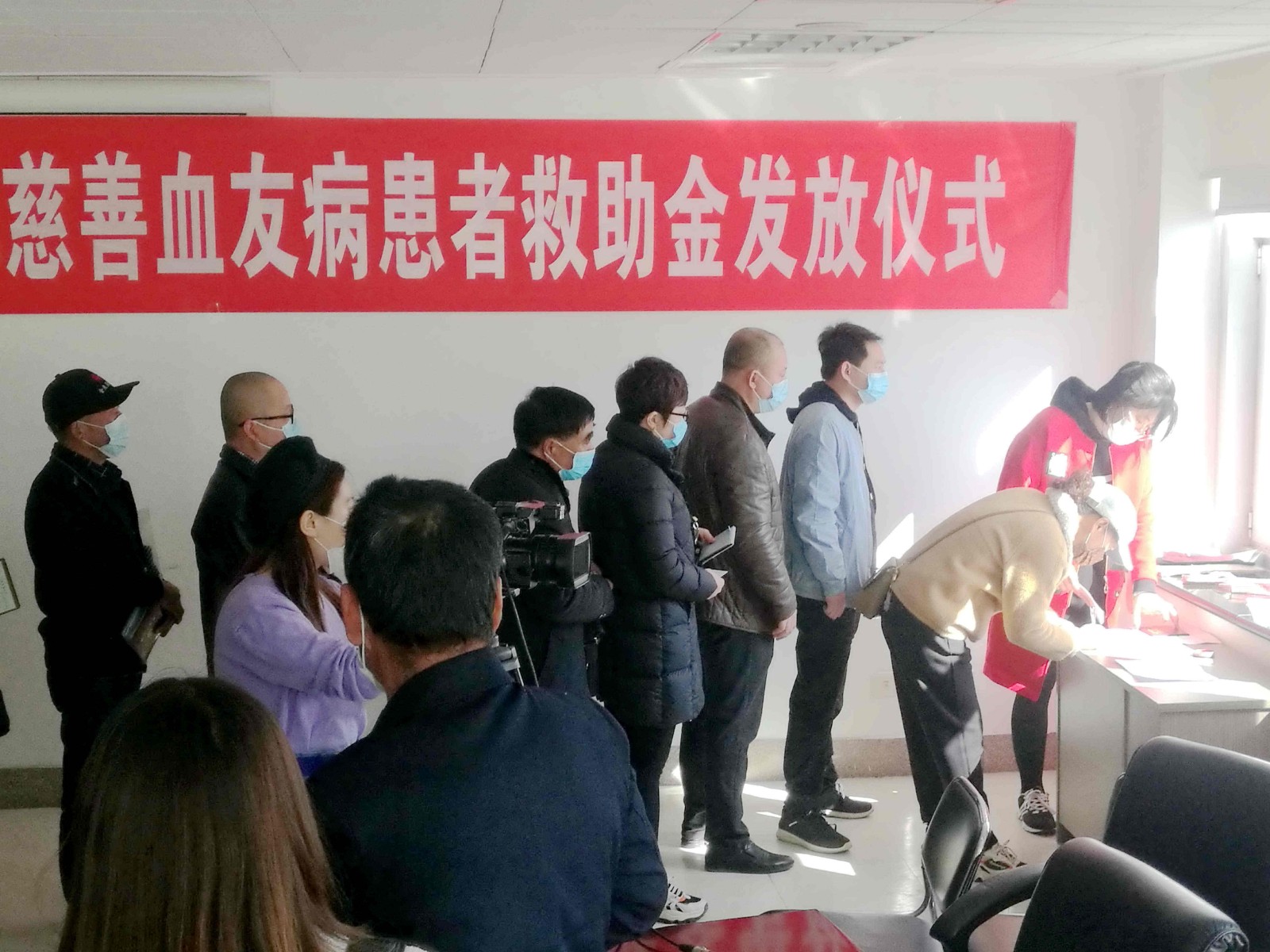 3受助的血友病患者在领取救助金.jpg